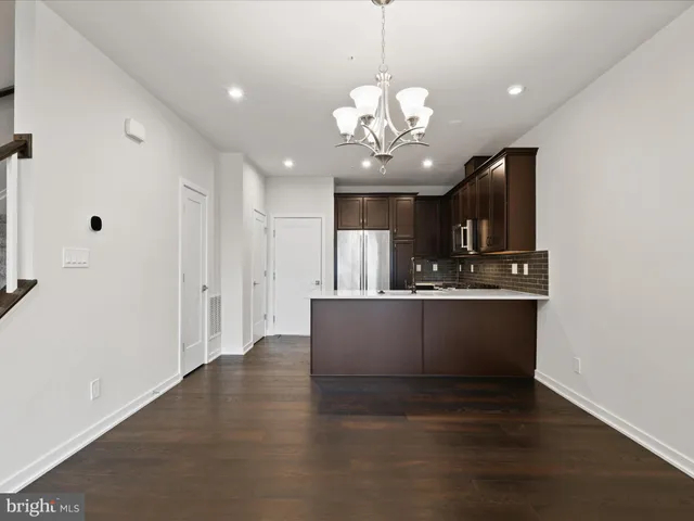 a view of kitchen with refrigerator microwave and stove