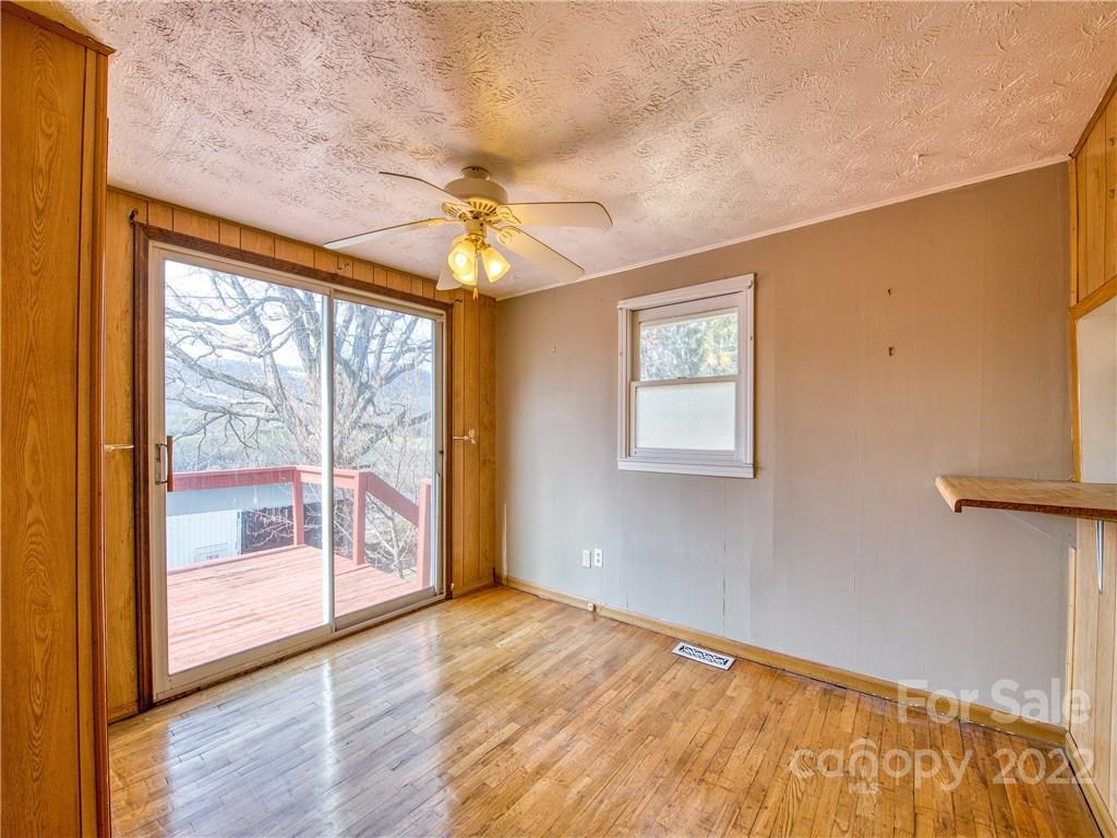 220 Center Pigeon Road Canton, NC 28716 - Photo 14 of 24 a view of empty room with wooden floor and fan