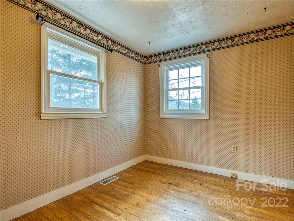 220 Center Pigeon Road Canton, NC 28716 - Photo 16 of 24 a view of an empty room with a window and wooden floor