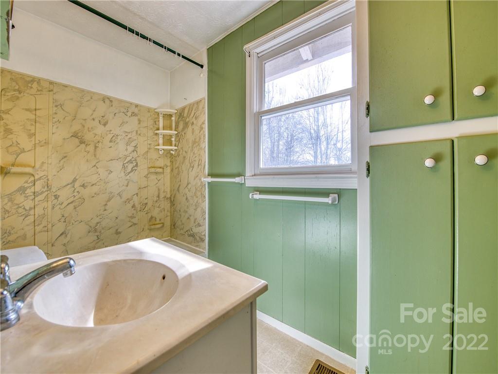 220 Center Pigeon Road Canton, NC 28716 - Photo 17 of 24 a bathroom with a sink and a tub