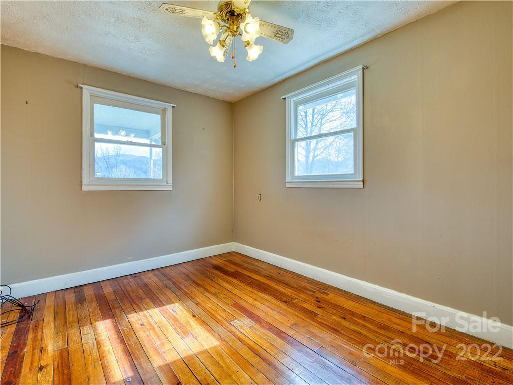220 Center Pigeon Road Canton, NC 28716 - Photo 18 of 24 a view of an empty room with wooden floor and a window