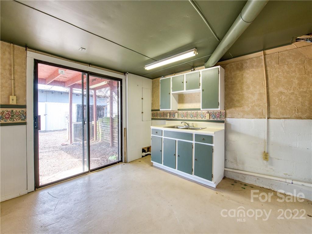 220 Center Pigeon Road Canton, NC 28716 - Photo 20 of 24 a view of a kitchen with a stove cabinets and a floor to ceiling window