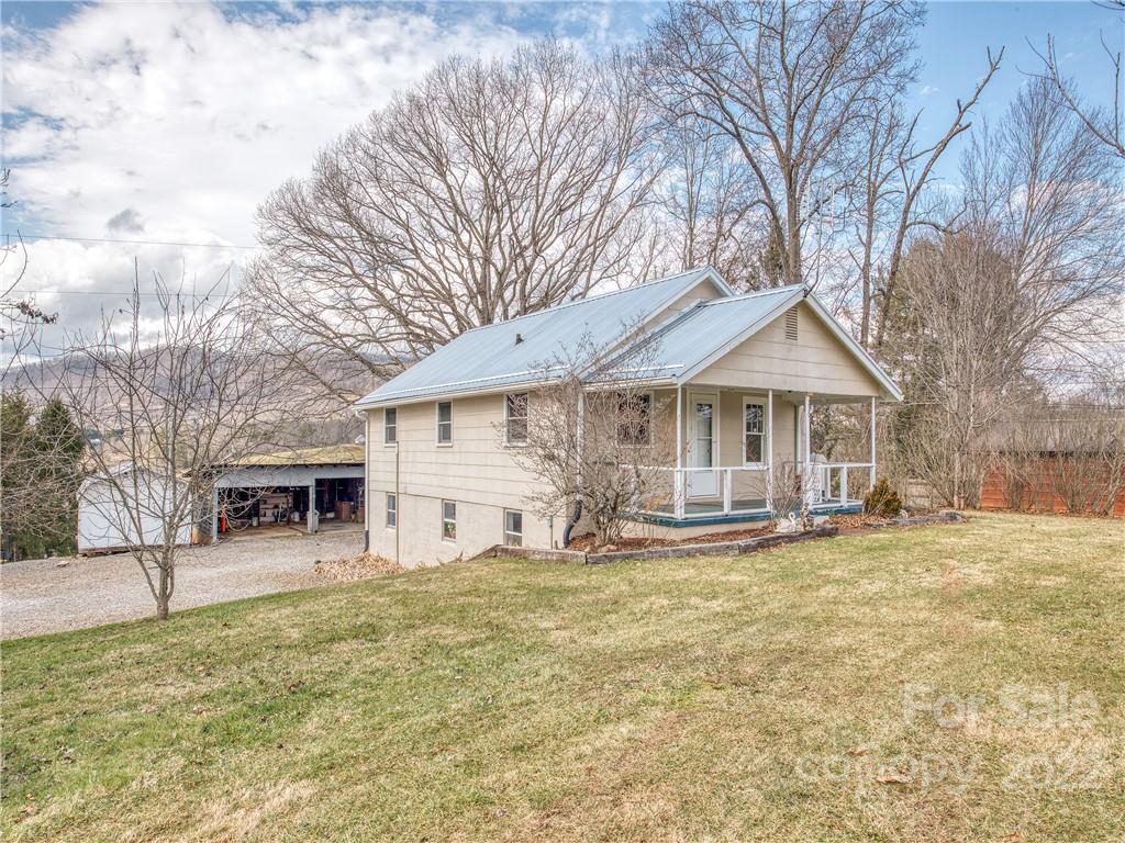 220 Center Pigeon Road Canton, NC 28716 - Photo 2 of 24 a front view of house with yard and trees in the background