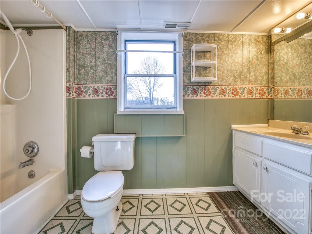 220 Center Pigeon Road Canton, NC 28716 - Photo 23 of 24 a bathroom with a sink a toilet a window and shower