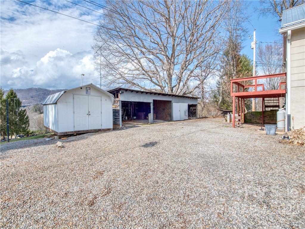 220 Center Pigeon Road Canton, NC 28716 - Photo 5 of 24 a view of a house with a yard and garage