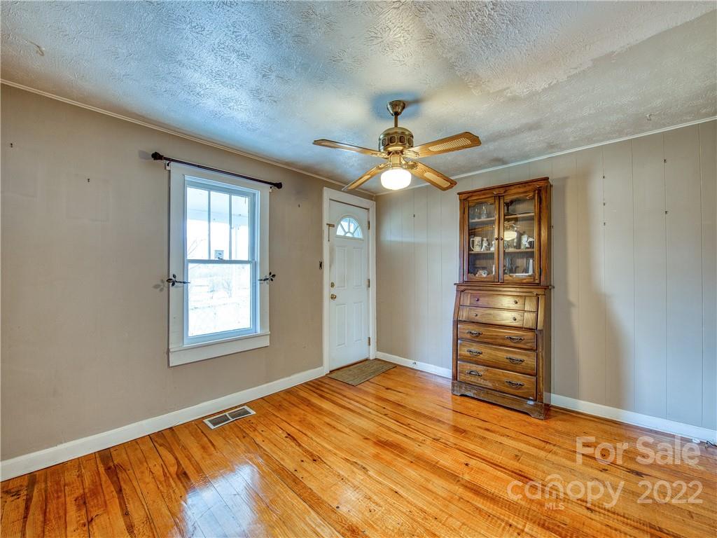 220 Center Pigeon Road Canton, NC 28716 - Photo 10 of 24 an empty room with windows and ceiling fan