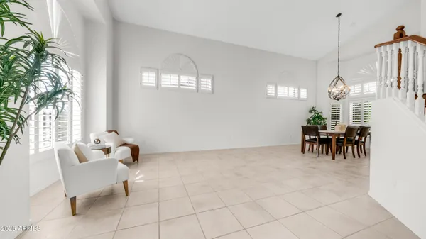 a bedroom with a bed ceiling fan and a window