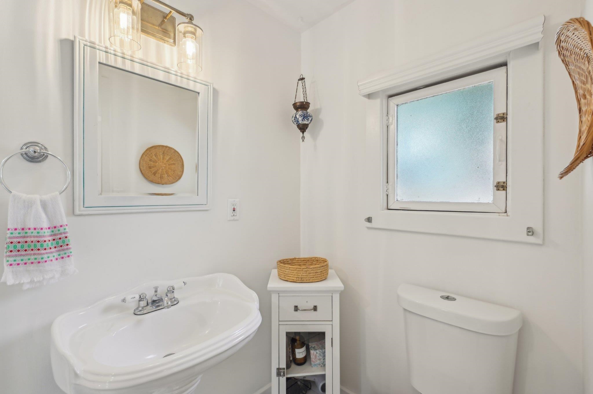 7 Atlantic Avenue St. Augustine, FL 32084 - Photo 27 of 38 a bathroom with a sink a toilet and a mirror