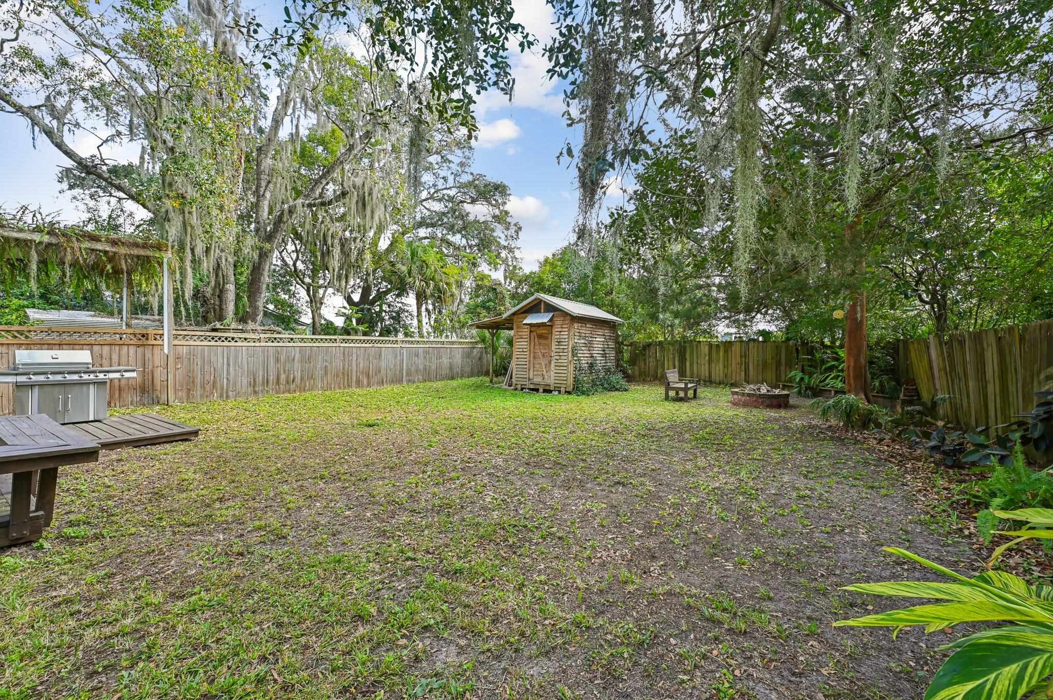 7 Atlantic Avenue St. Augustine, FL 32084 - Photo 29 of 38 a view of a backyard with large trees and wooden fence