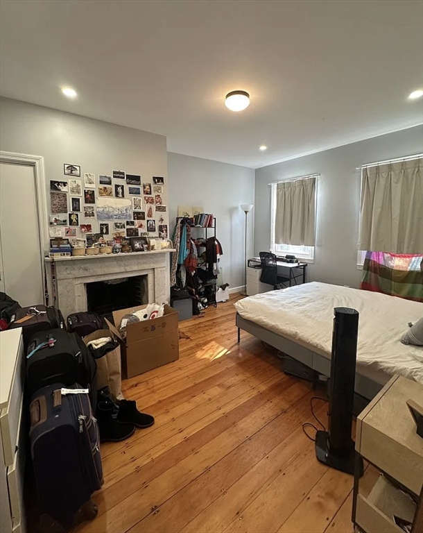 183 Prospect Street, Unit 2 Cambridge, MA 02139 - Photo 7 of 11 a living room with furniture a fireplace and gym equipment