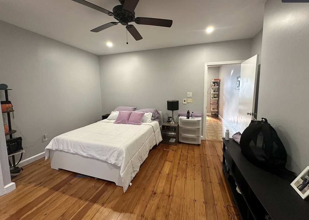 183 Prospect Street, Unit 2 Cambridge, MA 02139 - Photo 10 of 11 a spacious bedroom with a bed and wooden floor