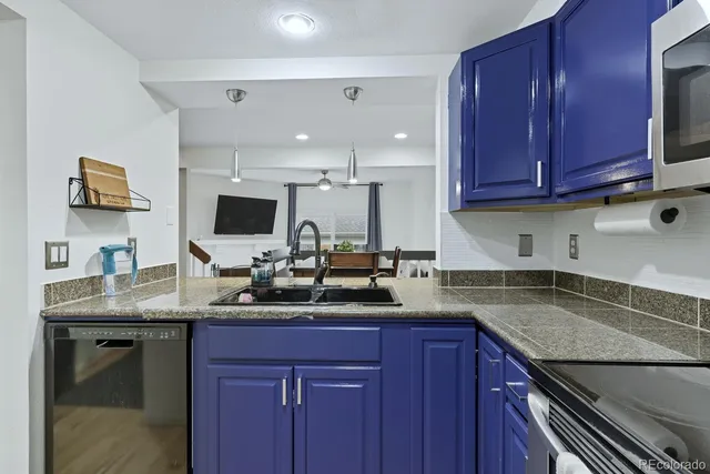 a kitchen with granite countertop a sink and cabinets