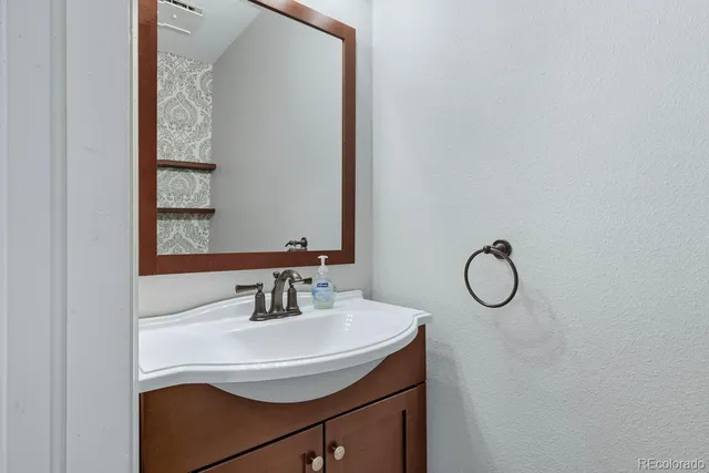 a bathroom with a sink and a mirror