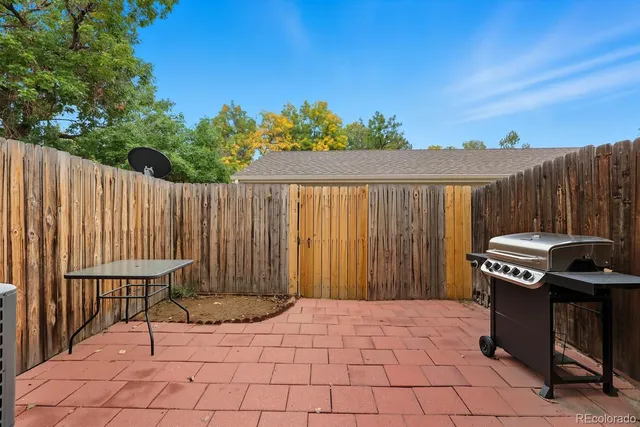 a backyard of a house with barbeque oven