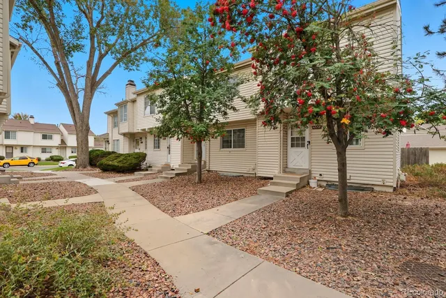 a tree in front of a house