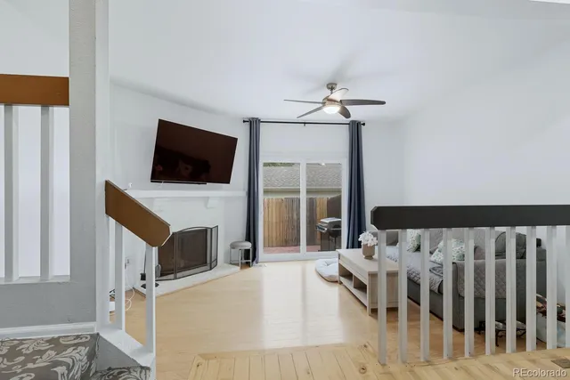 a living room with furniture a fireplace and a flat screen tv