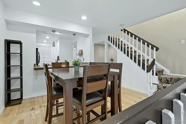 a dining room with furniture and wooden floor
