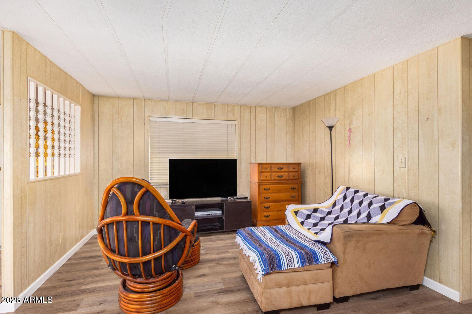 5546 East Player Place Mesa, AZ 85215 - Photo 3 of 8 a living room with furniture a flat screen tv and a window