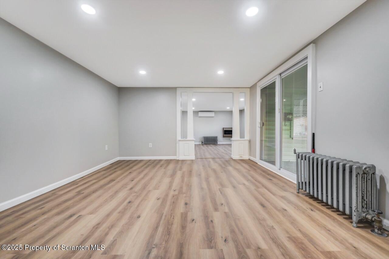 201 Jackson Street Olyphant, PA 18447 - Photo 12 of 70 a view of empty room with wooden floor and floor to ceiling window