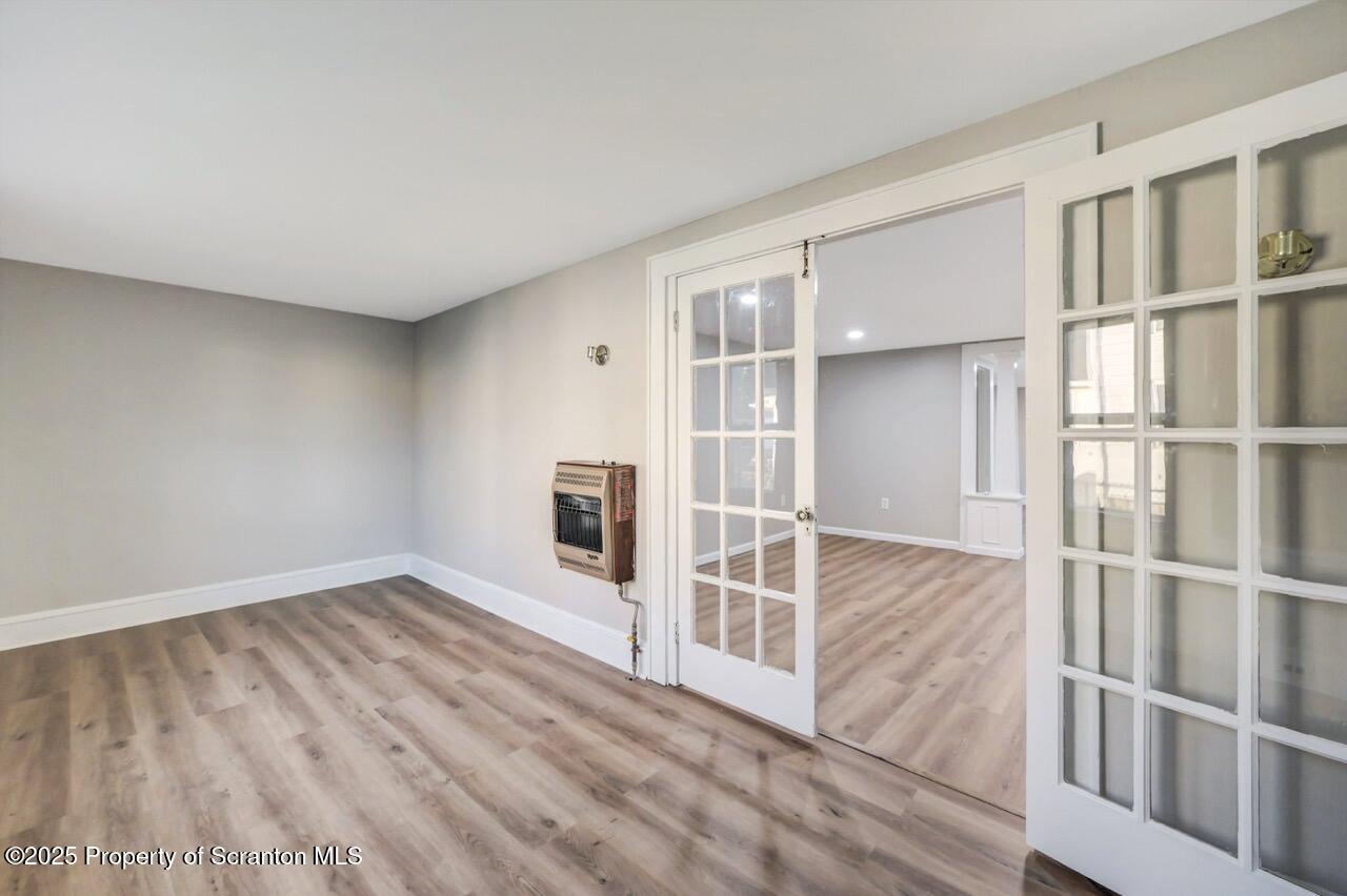 201 Jackson Street Olyphant, PA 18447 - Photo 14 of 70 a view of an empty room with wooden floor and a window