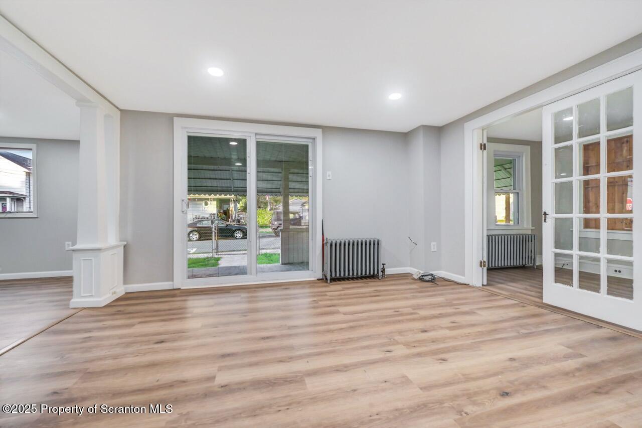 201 Jackson Street Olyphant, PA 18447 - Photo 17 of 70 a view of an empty room with wooden floor and a window