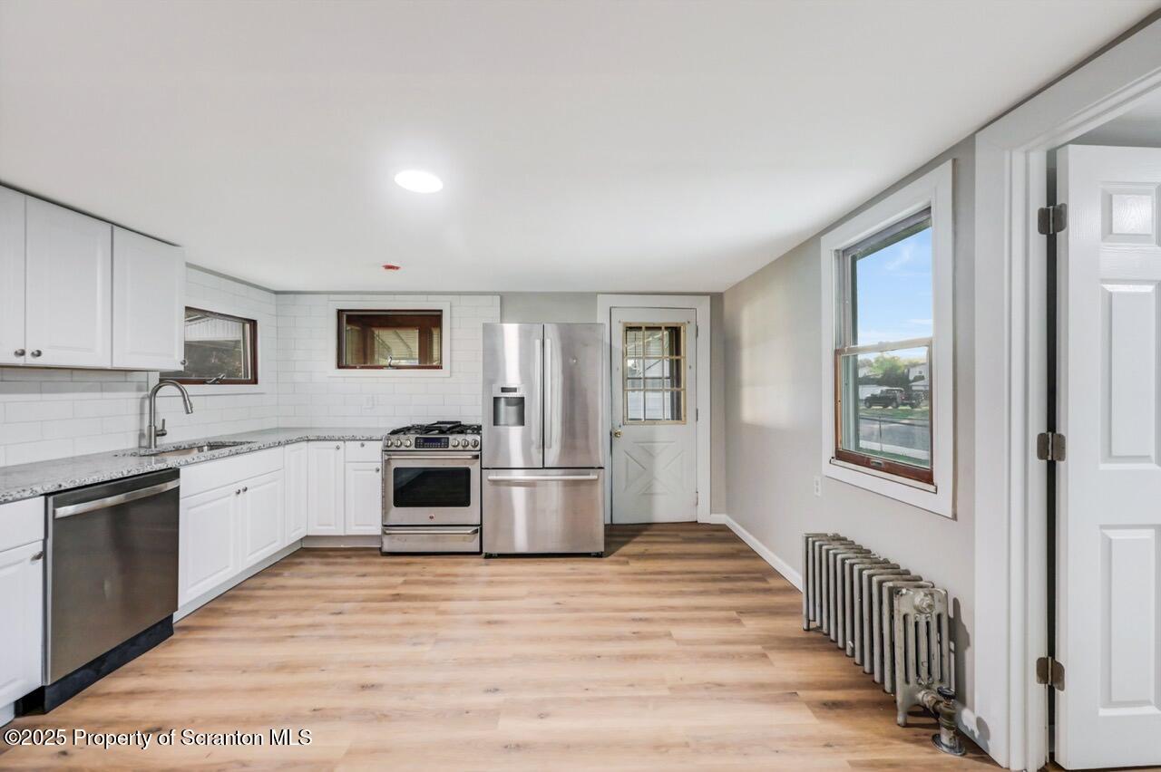 201 Jackson Street Olyphant, PA 18447 - Photo 29 of 70 a large kitchen with stainless steel appliances granite countertop a stove and a sink