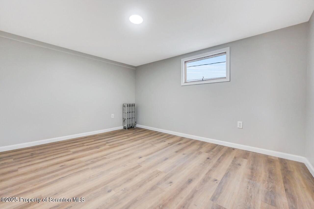 201 Jackson Street Olyphant, PA 18447 - Photo 40 of 70 a view of an empty room with wooden floor and a window