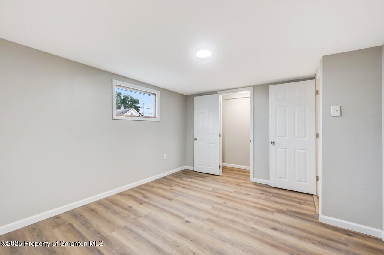 201 Jackson Street Olyphant, PA 18447 - Photo 42 of 70 an empty room with wooden floor and window