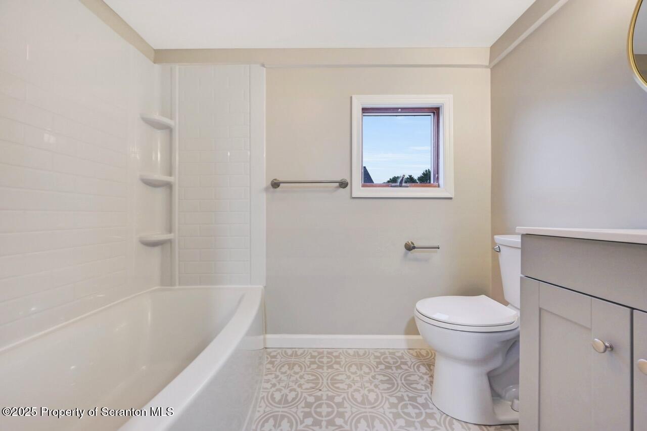 201 Jackson Street Olyphant, PA 18447 - Photo 50 of 70 a white toilet sitting next to a bath tub