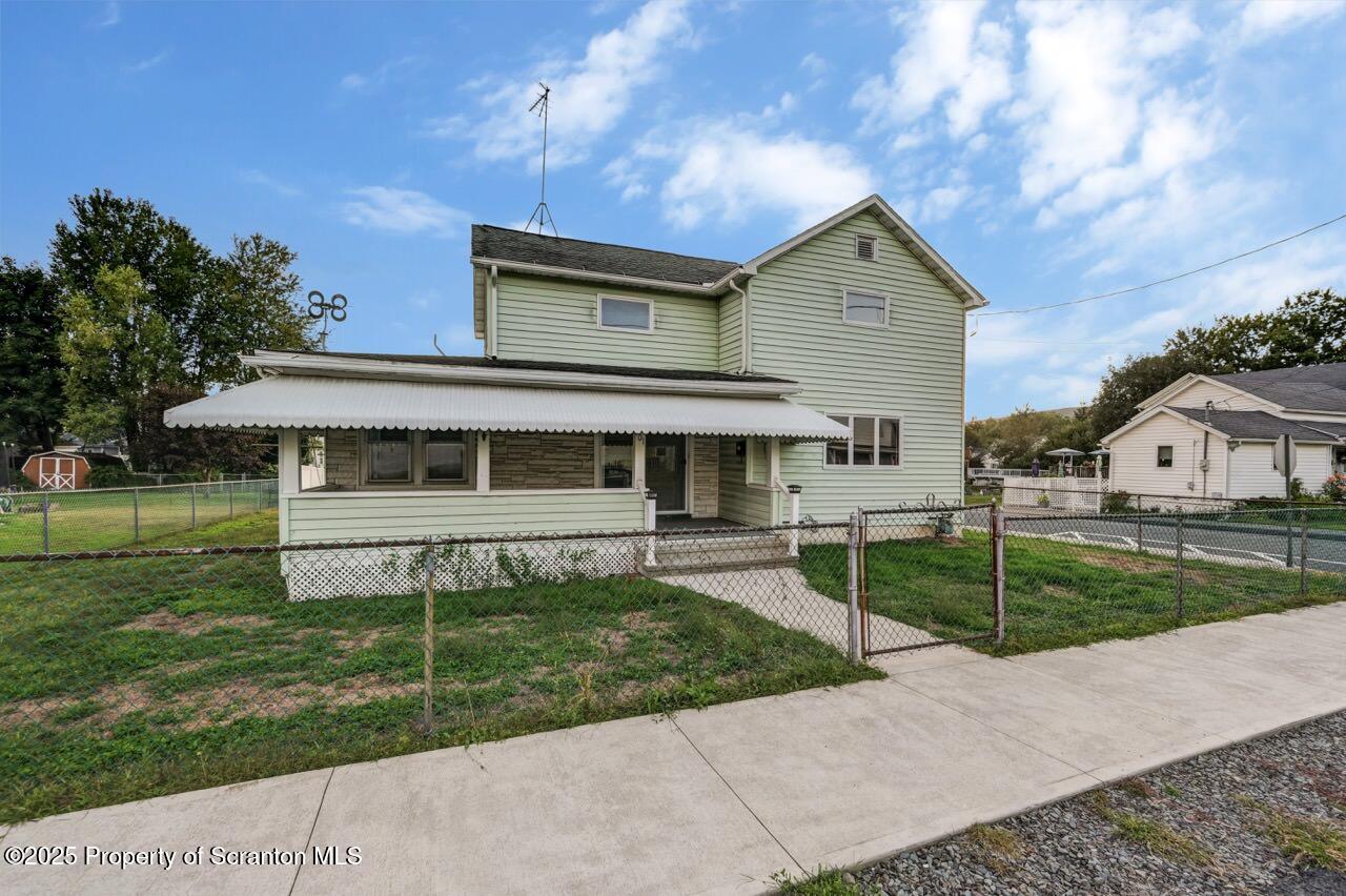 201 Jackson Street Olyphant, PA 18447 - Photo 70 of 70 a front view of a house with a yard and garage