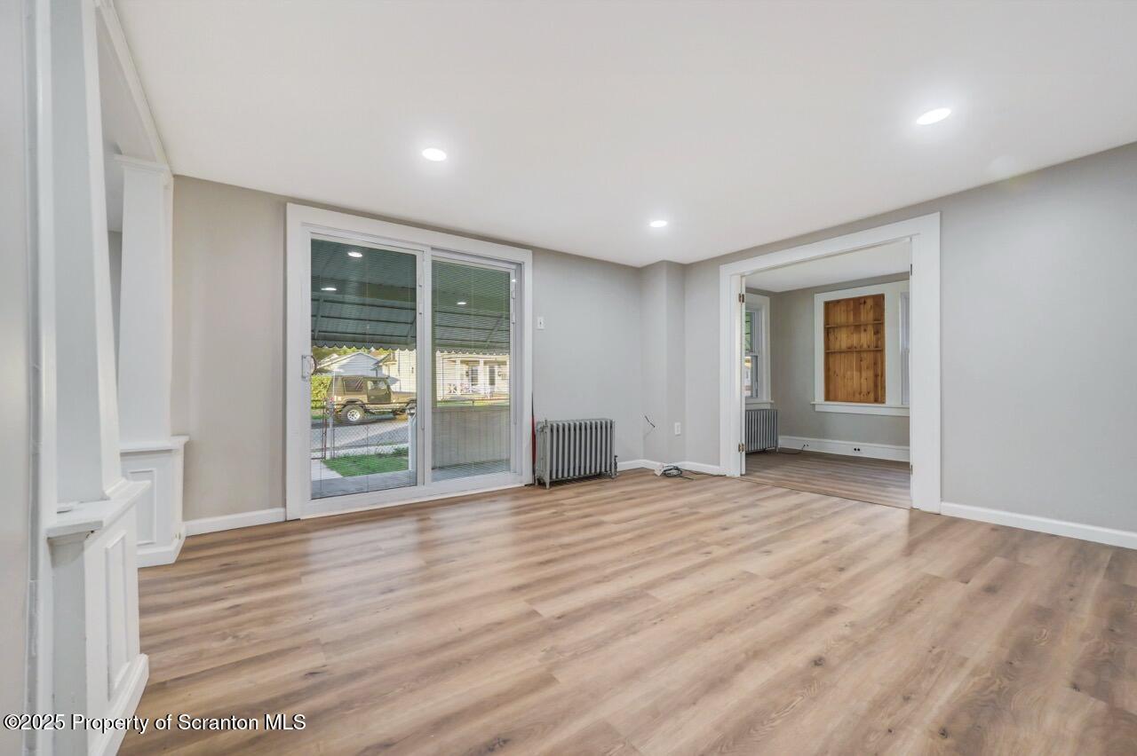 201 Jackson Street Olyphant, PA 18447 - Photo 8 of 70 a view of an empty room with wooden floor and a window