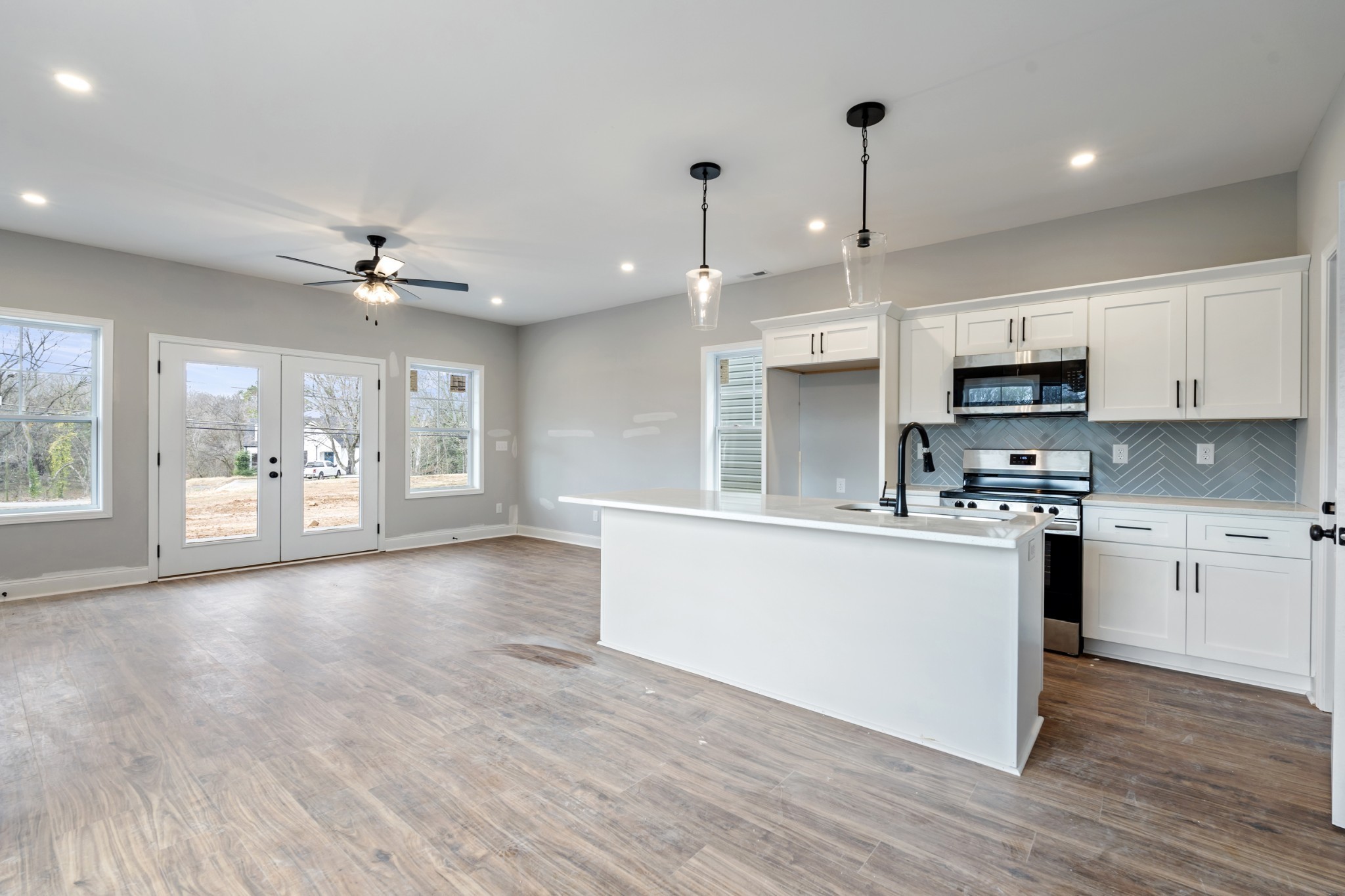 87 Charlotte Road Clarksville, TN 37040 - Photo 6 of 26 a large kitchen with stainless steel appliances granite countertop a stove top oven a sink dishwasher and a refrigerator with wooden floor