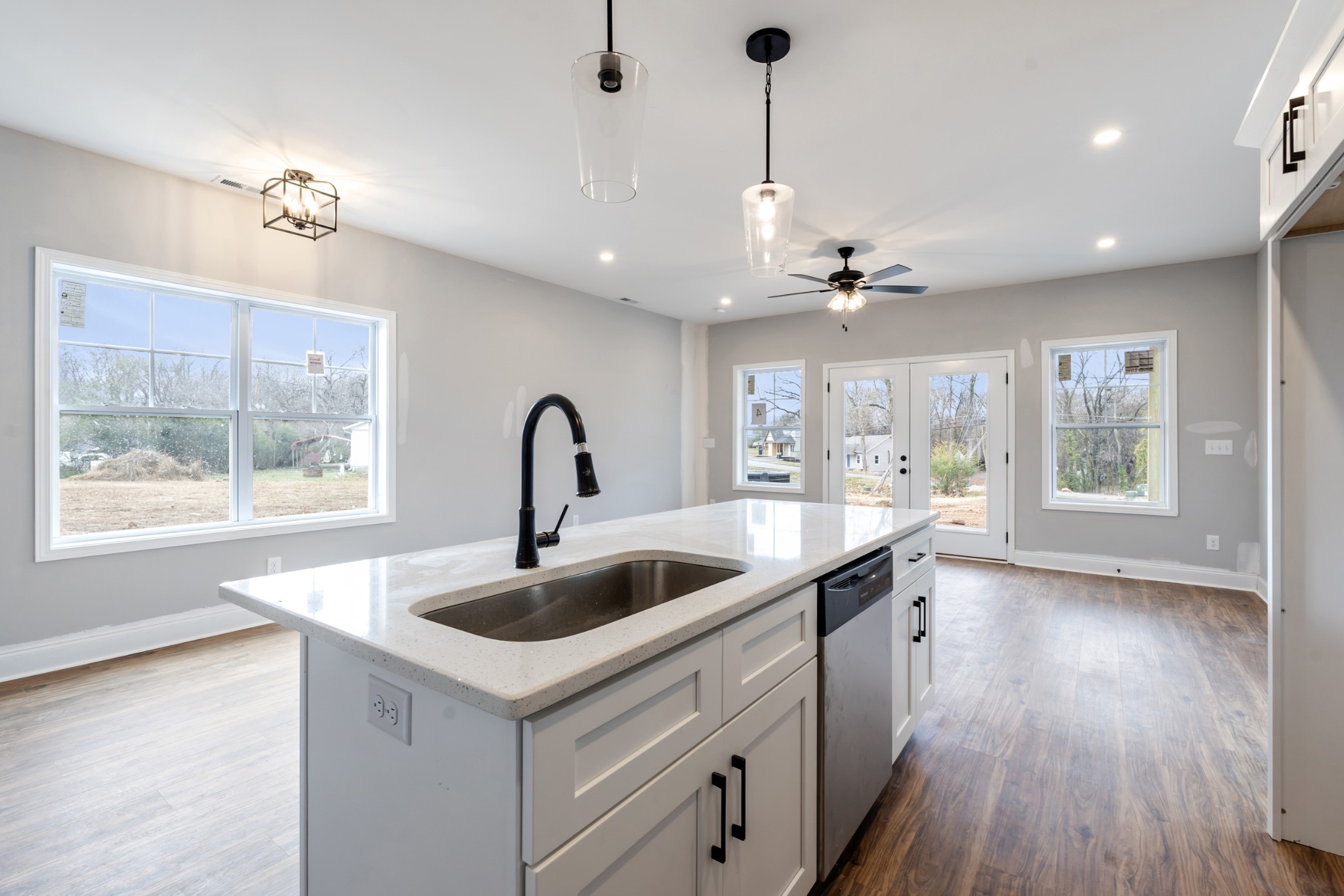 87 Charlotte Road Clarksville, TN 37040 - Photo 7 of 26 a kitchen with a sink a faucet a chandelier and wooden floor