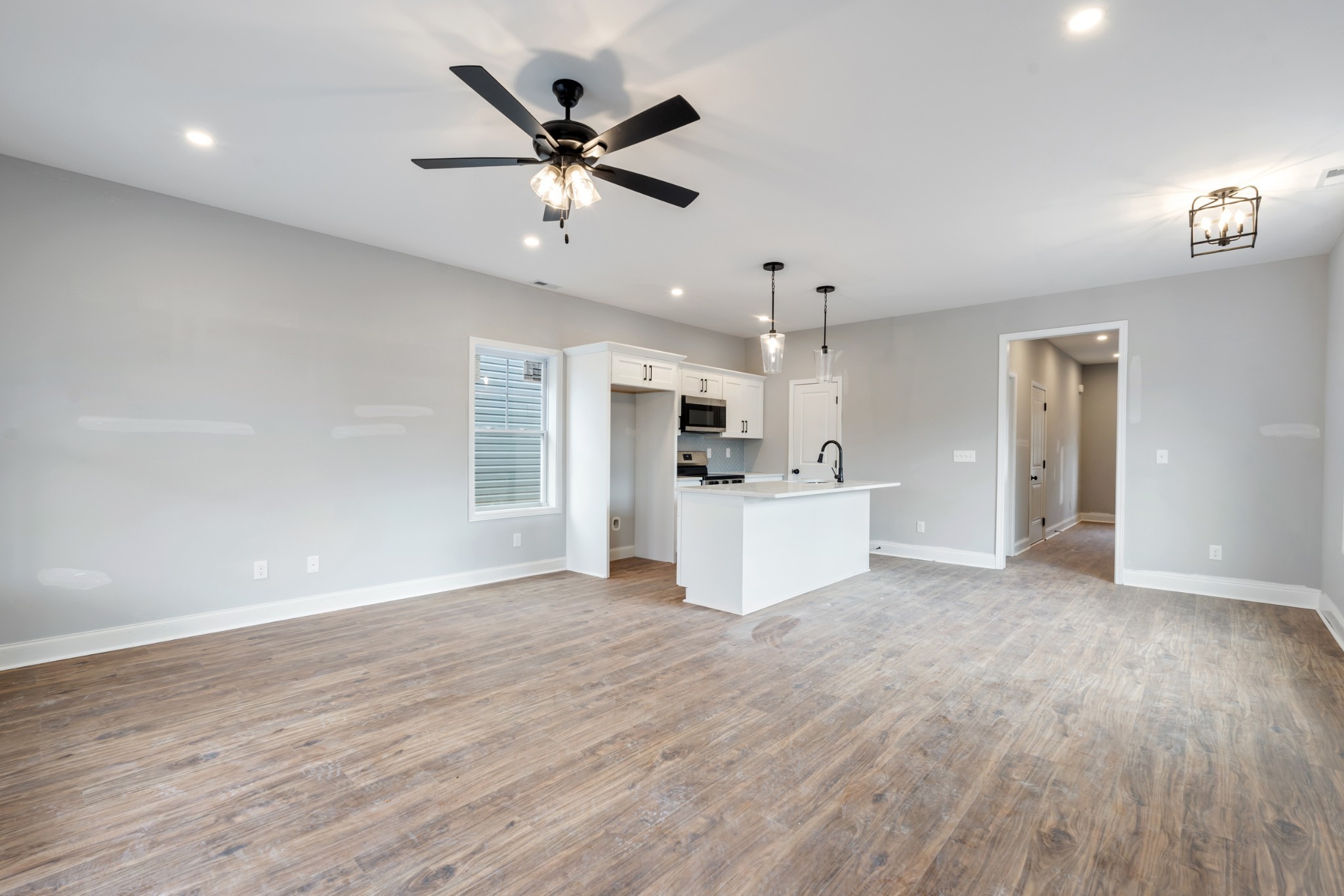 87 Charlotte Road Clarksville, TN 37040 - Photo 10 of 26 a view of a kitchen with wooden floor a sink and a window