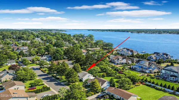 an aerial view of a houses with a yard
