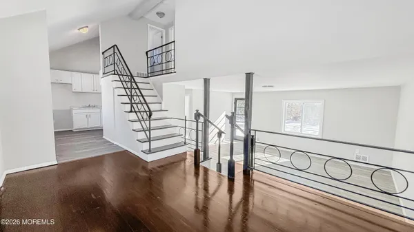 a view of entryway and hall with wooden floor
