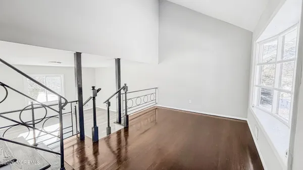 a view of an entryway with wooden floor