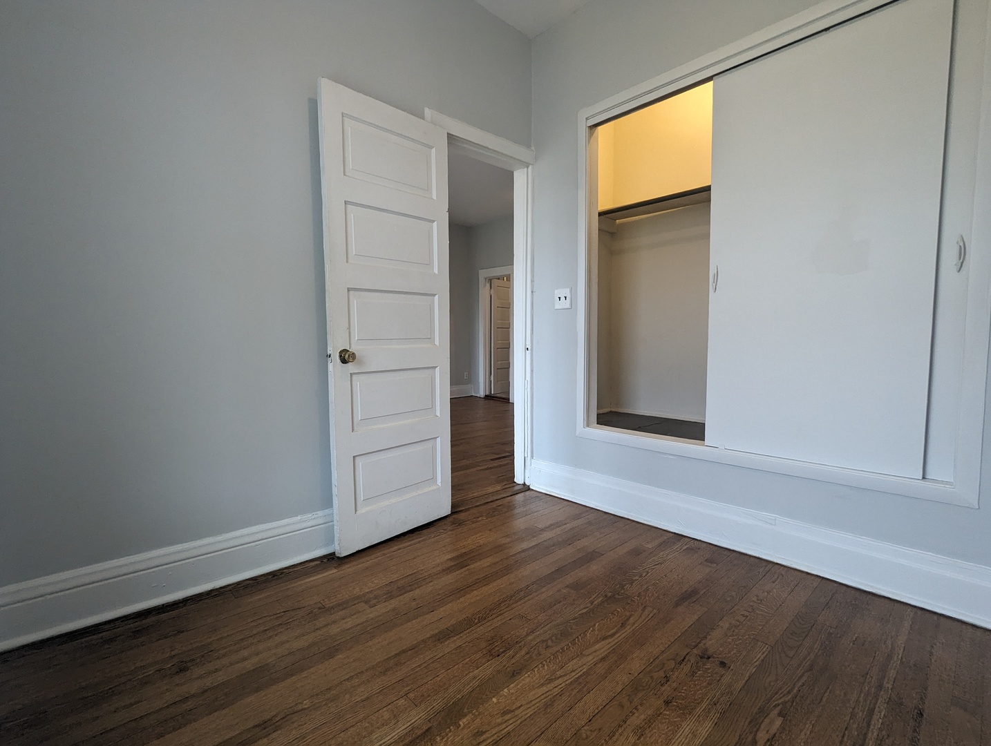 3544 North Halsted Street, Unit 3F Chicago, IL 60657 - Photo 13 of 28 an empty room with wooden floor and closet