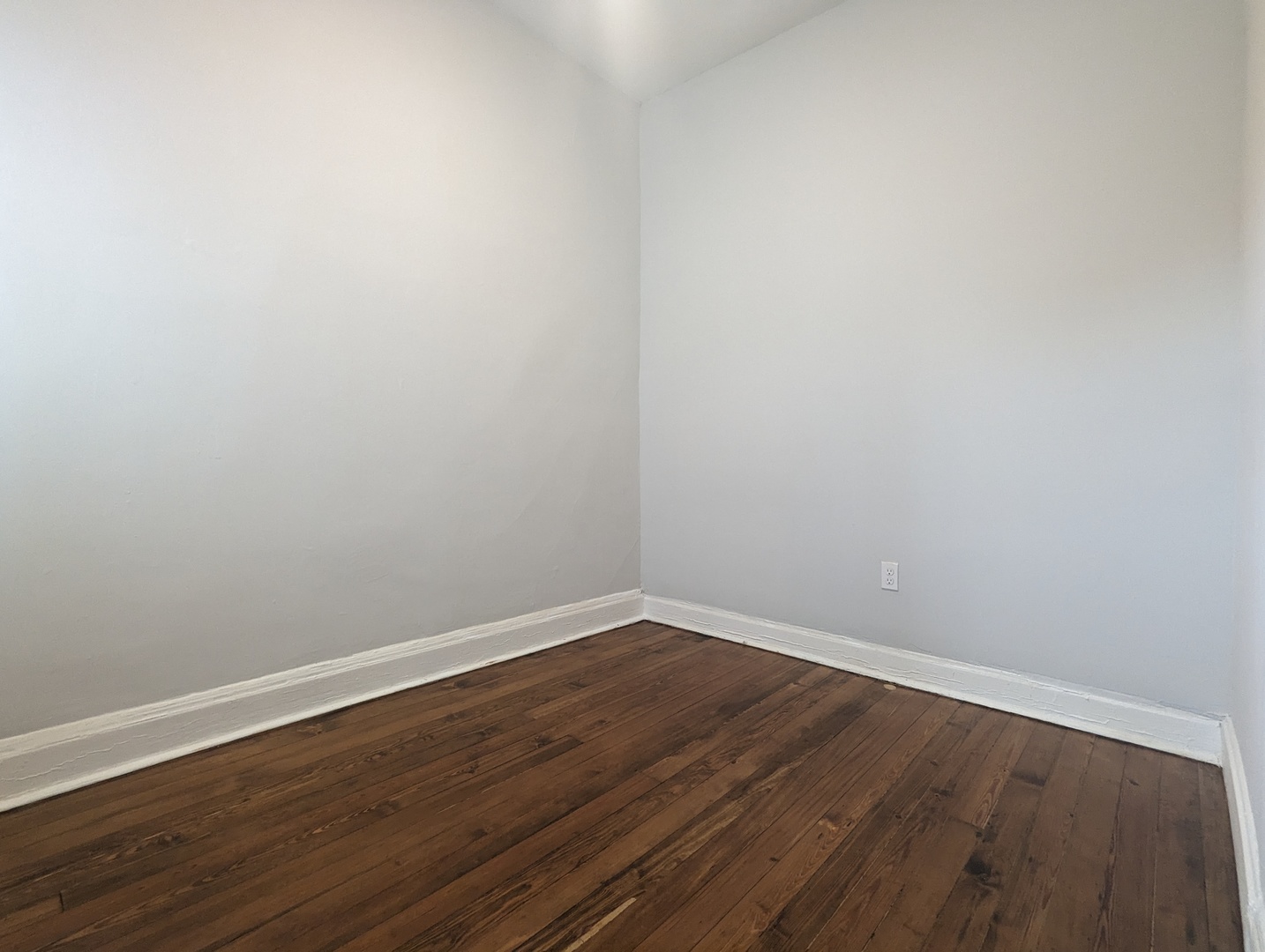 3544 North Halsted Street, Unit 3F Chicago, IL 60657 - Photo 18 of 28 a view of an empty room with wooden floor