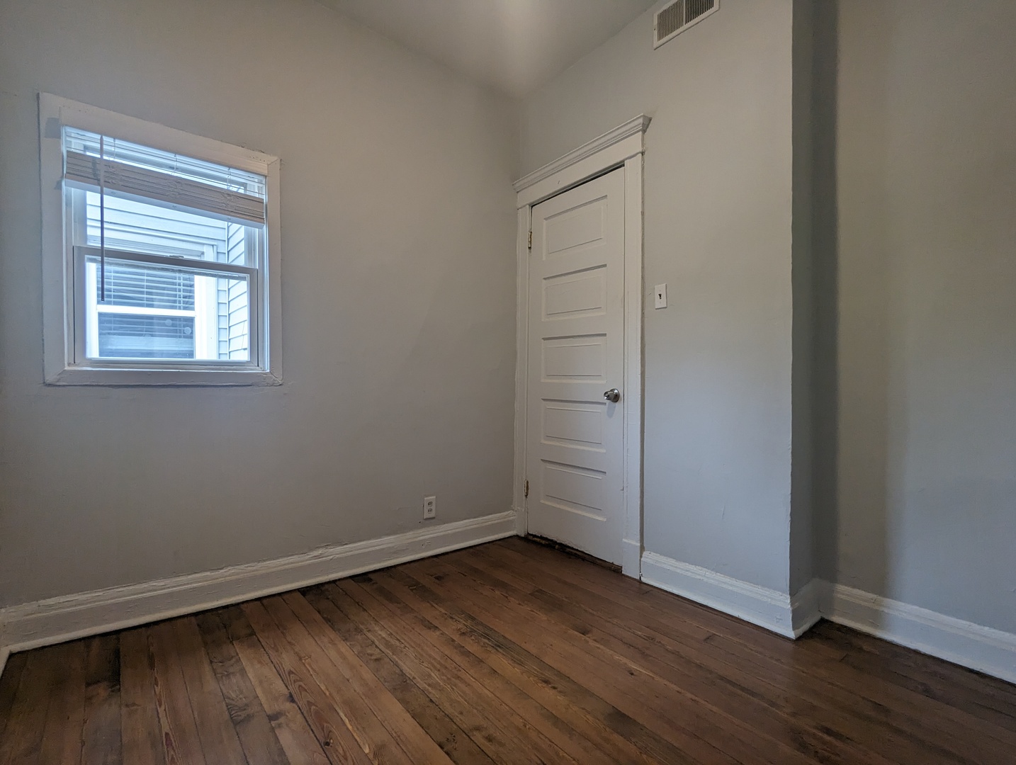 3544 North Halsted Street, Unit 3F Chicago, IL 60657 - Photo 27 of 28 an empty room with wooden floor and window