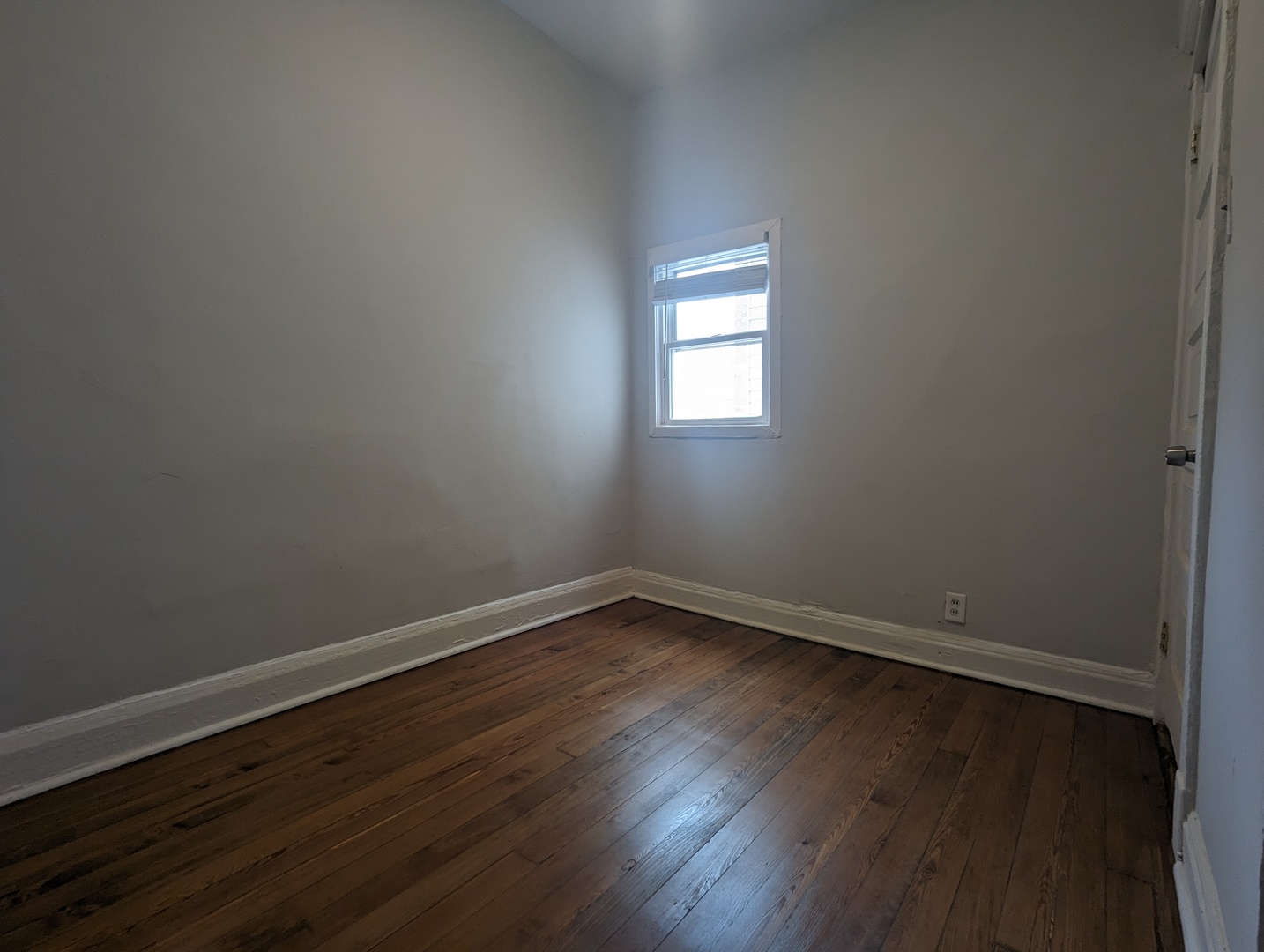 3544 North Halsted Street, Unit 3F Chicago, IL 60657 - Photo 28 of 28 a view of an empty room with wooden floor and a window
