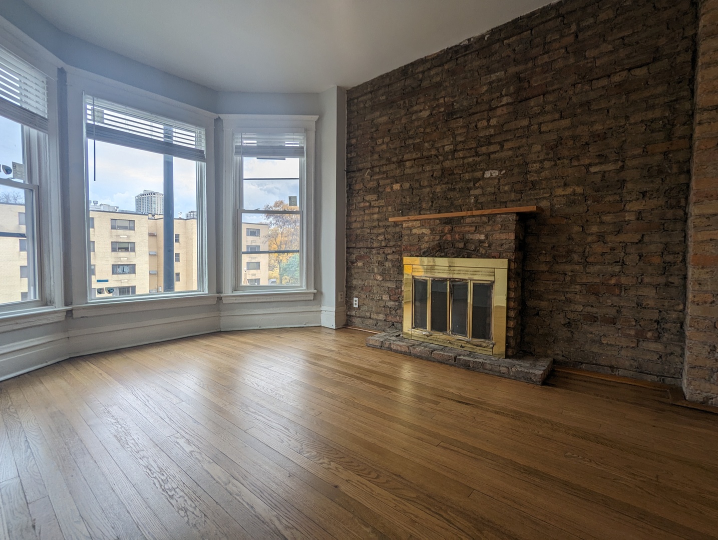 3544 North Halsted Street, Unit 3F Chicago, IL 60657 - Photo 4 of 28 wooden floor fireplace and windows in an empty room