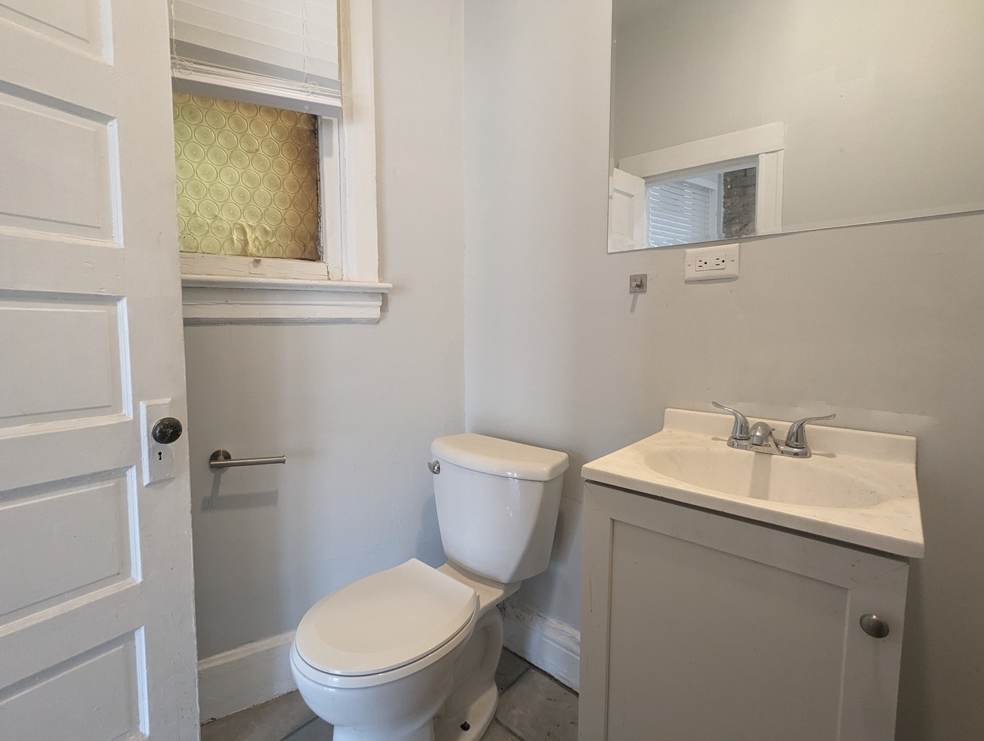 3544 North Halsted Street, Unit 3F Chicago, IL 60657 - Photo 10 of 28 a bathroom with a toilet sink vanity and mirror