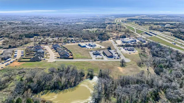 an aerial view of residential building and lake
