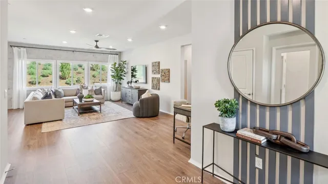 a living room with furniture fireplace and a large window