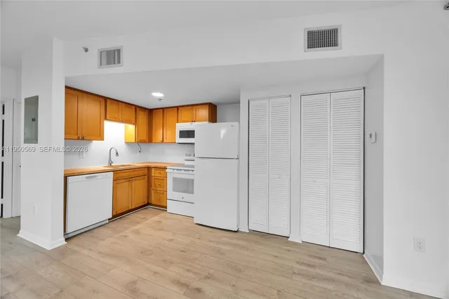 a kitchen with stainless steel appliances a refrigerator and a sink
