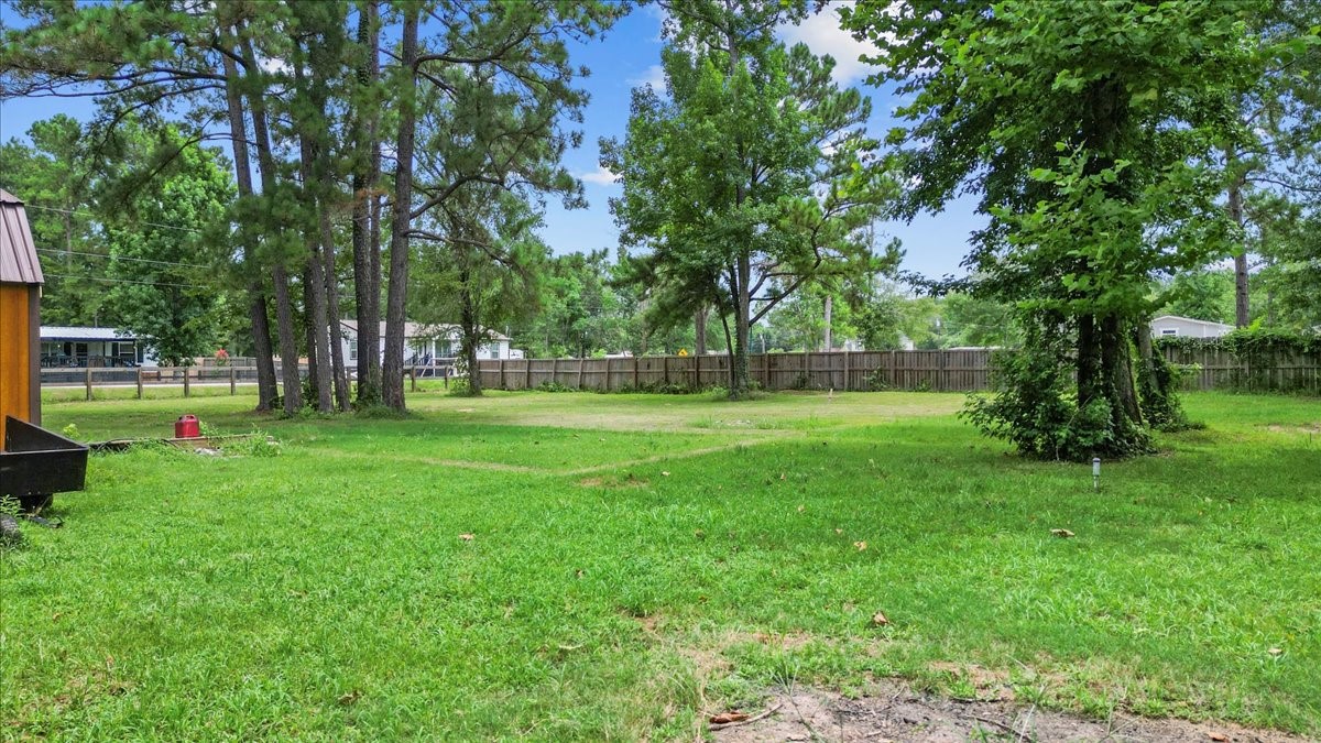 21658 County Road 3749D Cleveland, TX 77327 - Photo 14 of 26 a view of green field with trees in the background