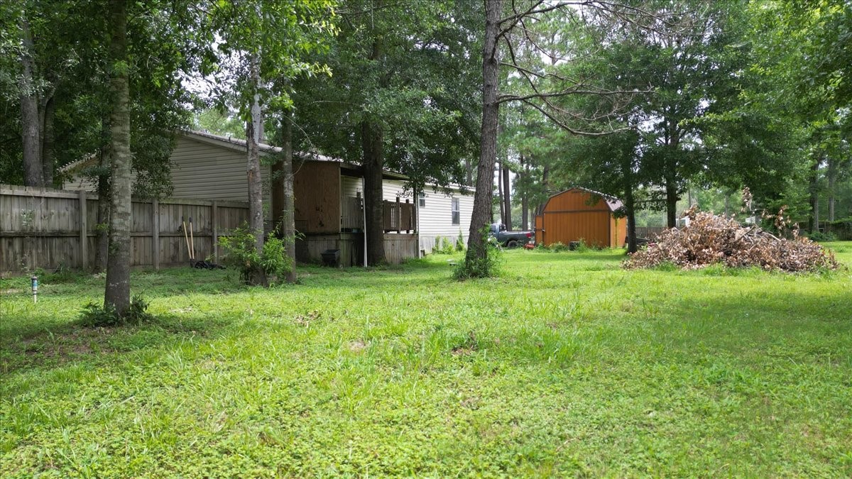 21658 County Road 3749D Cleveland, TX 77327 - Photo 25 of 26 a view of a house with backyard and sitting area