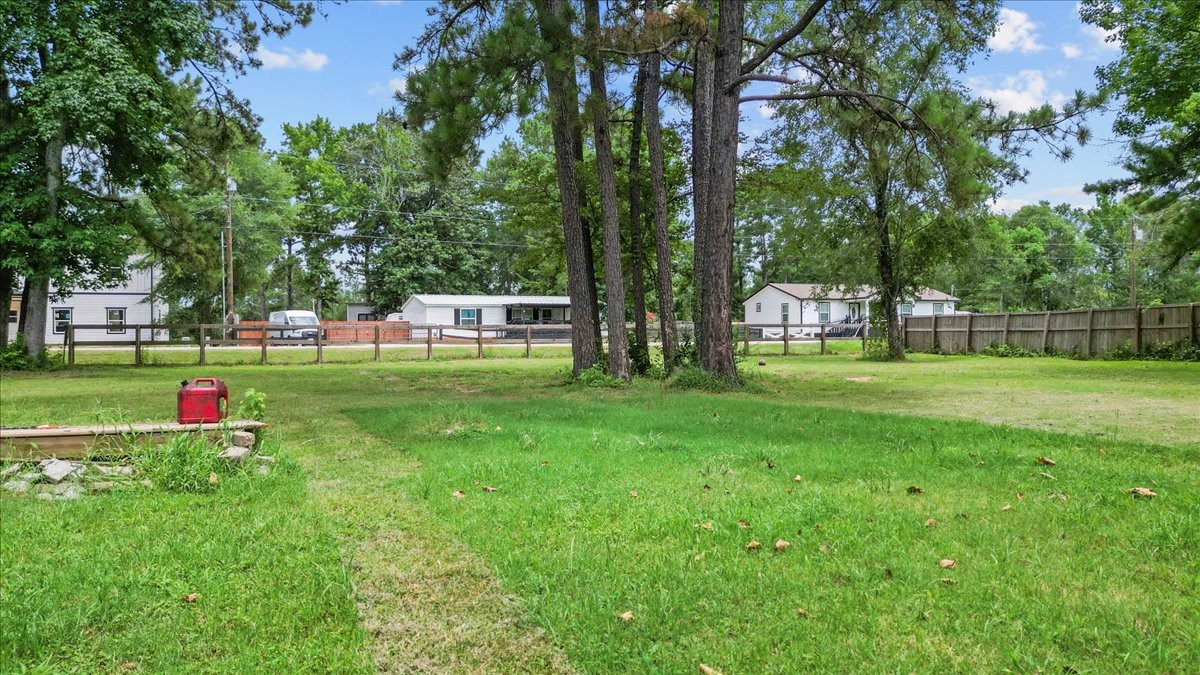 21658 County Road 3749D Cleveland, TX 77327 - Photo 7 of 26 a view of a park with trees in the background