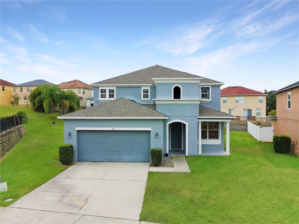 a front view of a house with a yard
